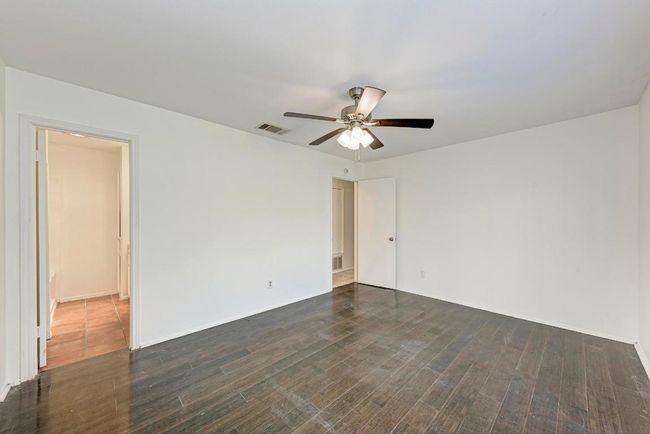 Spare room featuring visible vents, ceiling fan, and dark wood finished floors | Image 18