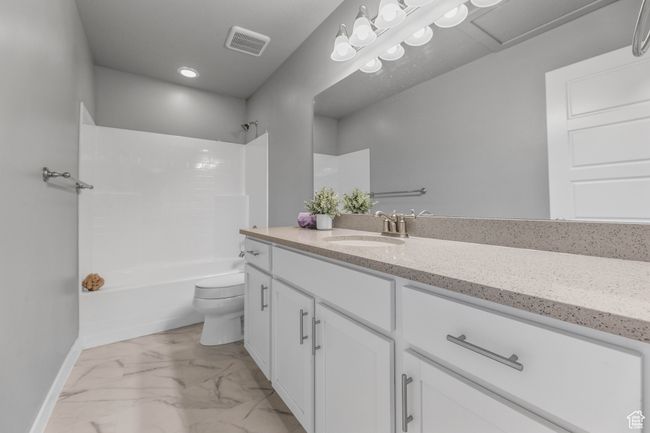 Full bathroom with toilet, baseboards, visible vents, marble finish floor, and vanity | Image 29
