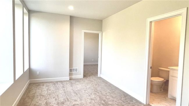 Just off the stairs, this room works beautifully as a reading room, office, or sun room! | Image 39