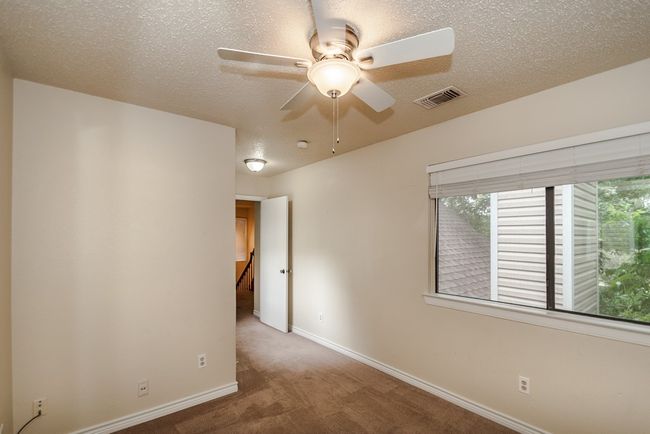 Unfurnished room featuring carpet floors, ceiling fan, and a textured ceiling | Image 16