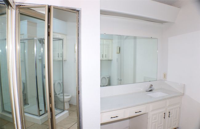 Full bathroom featuring vanity, a stall shower, and tile patterned flooring | Image 26