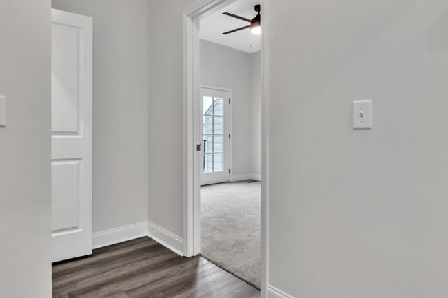 3rd floor landing with laundry room entry to 2nd guest bedroom. | Image 20