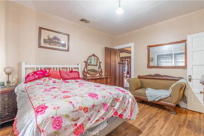 Cozy and serene—wood-framed windows and natural light make this primary bedroom a retreat. | Image 31