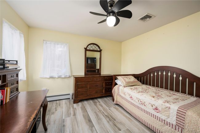 Rec room featuring dark wood-type flooring and a baseboard radiator | Image 14