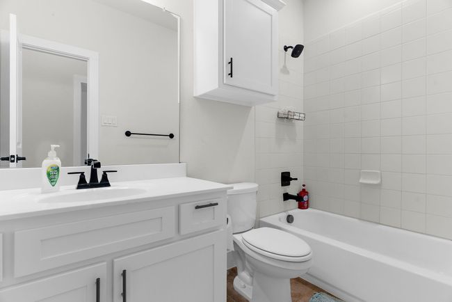 Bathroom featuring toilet, vanity, and bathing tub / shower combination | Image 20