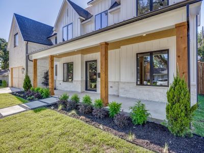 View of front facade with a garage, a porch, and a front lawn | Image 2