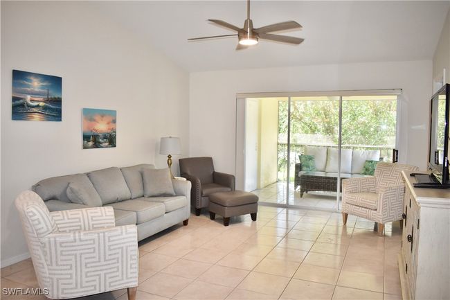 Tiled living room with ceiling fan and vaulted ceiling | Image 6