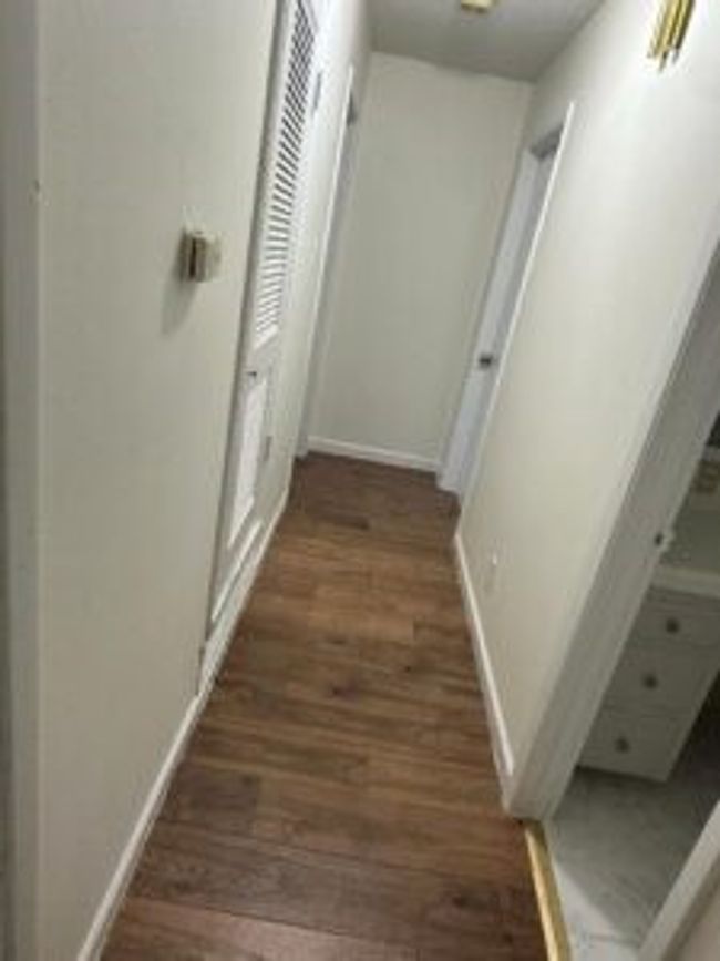 Hall with wood finished floors and baseboards | Image 16
