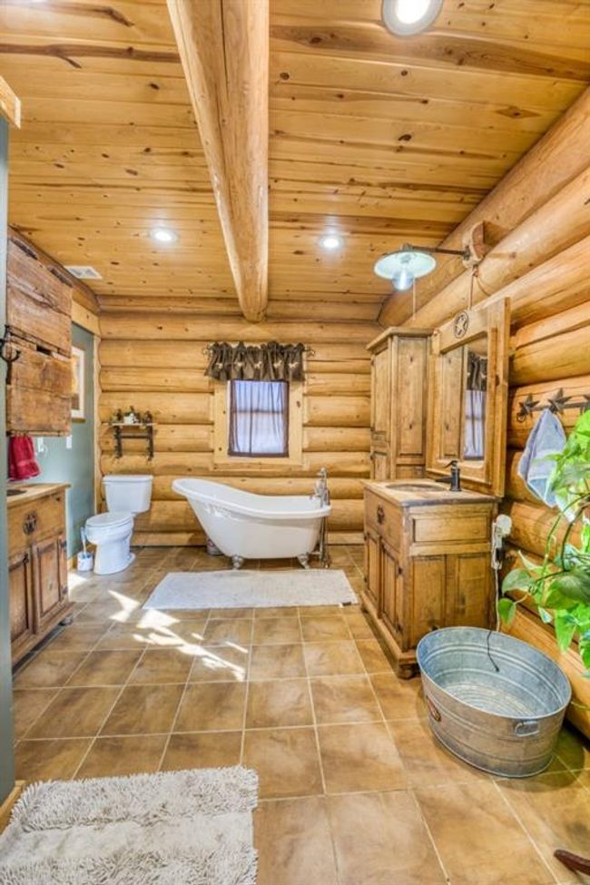Bathroom with toilet, recessed lighting, wooden ceiling, a freestanding bath, and vanity | Image 24