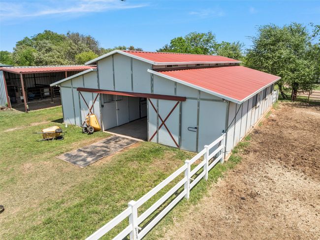 View of pole building with a yard and fence | Image 28