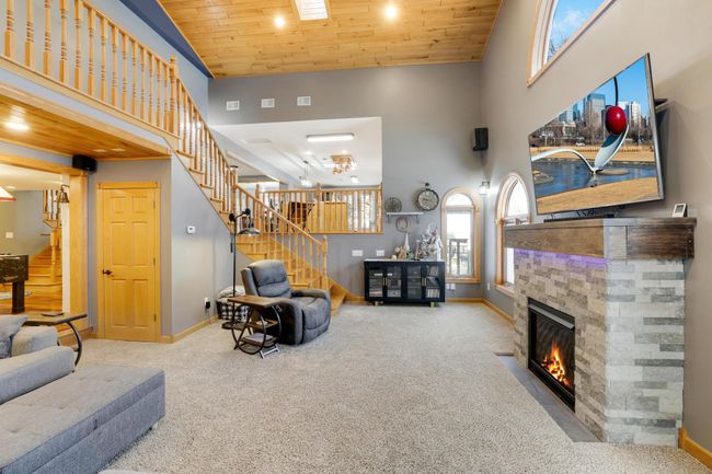 Custom gas fireplace has built-in compartments and beautiful stone accents. | Image 19