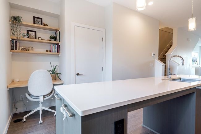 Office featuring wood finished floors, baseboards, and a sink | Image 7