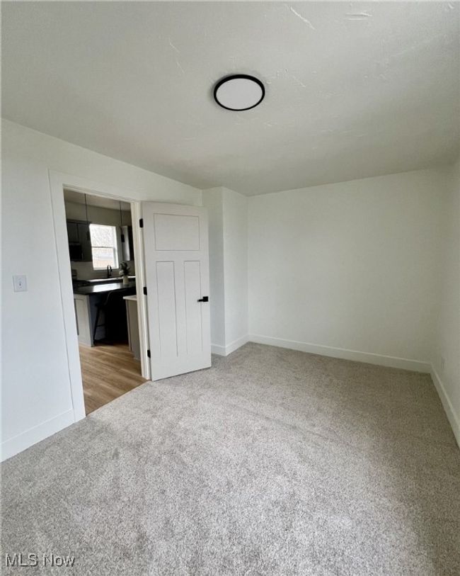 Spare room featuring light colored carpet and baseboards | Image 17
