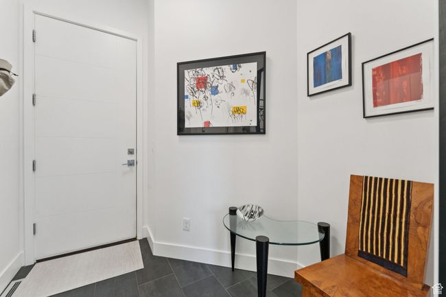 Foyer entrance featuring baseboards and dark tile patterned floors | Image 37