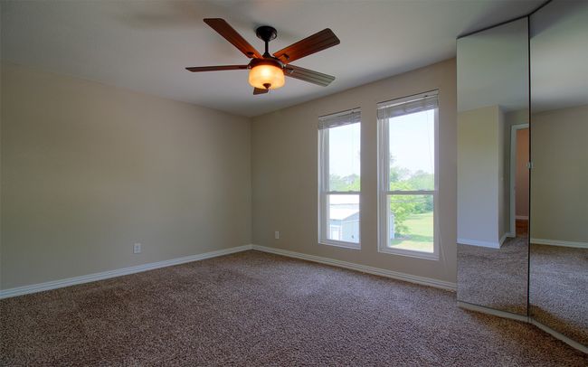 Unfurnished room with ceiling fan, carpet floors, and baseboards | Image 16
