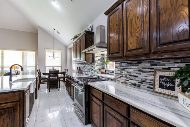 The kitchen includes a window and is conveniently open to a sunny breakfast area. | Image 12