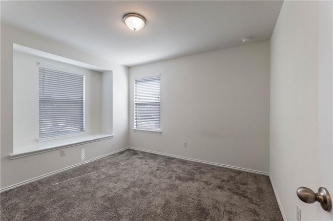 Unfurnished room with carpet floors and a smoke detector | Image 25