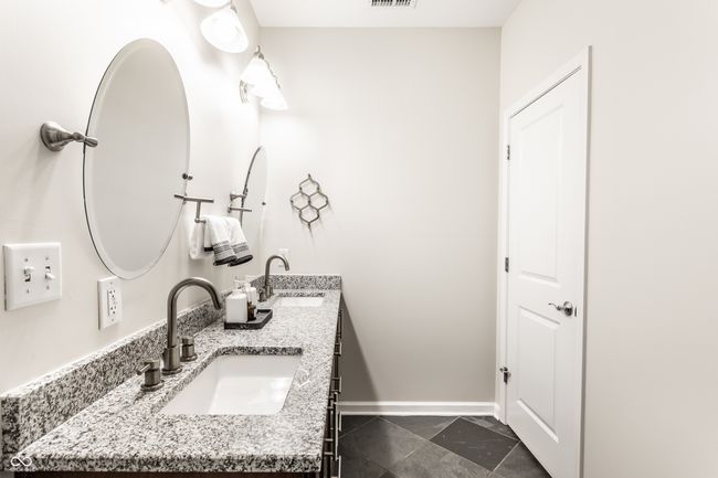 bathroom featuring double vanity and baseboards | Image 22