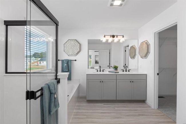 Bathroom featuring vanity, hardwood / wood-style floors, and a washtub | Image 29