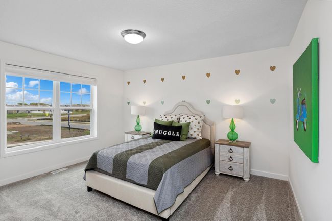Photo is of the actual model. One of three generously sized upper-level secondary bedrooms with spacious closets. | Image 21