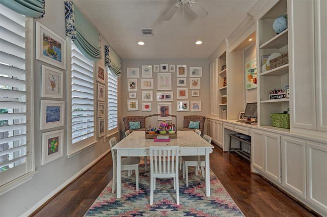 Wall of windows (side of home) with 5" custom wood shutters. A great space for multiple uses. | Image 24