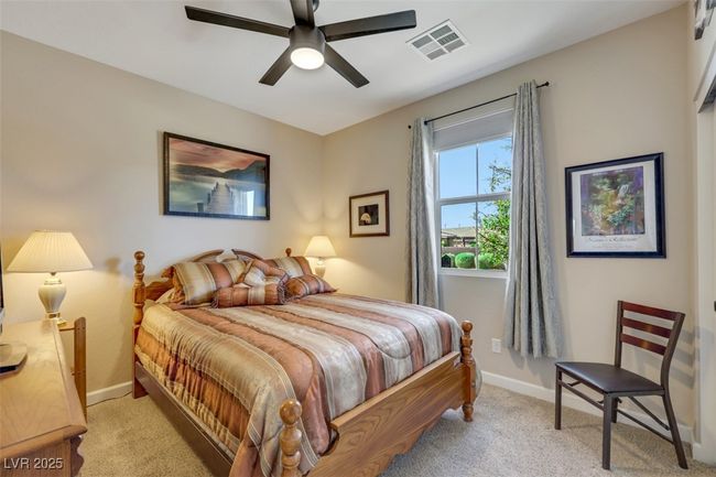 Bedroom with baseboards, visible vents, a ceiling fan, and light carpet | Image 30
