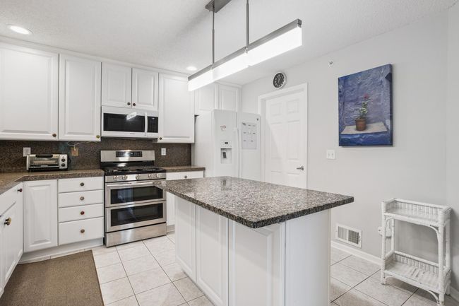 Light and Bright with Upgraded Lighting - Room for Dining Stools at the Island | Image 13