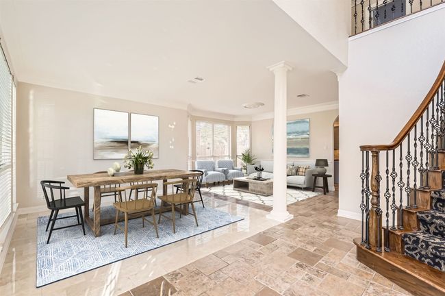 Dining area with stairs, arched walkways, baseboards, visible vents, and ornate columns | Image 20