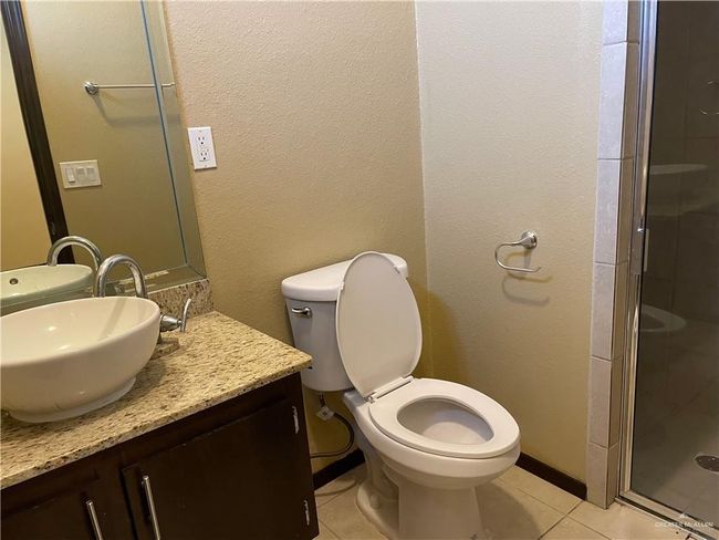 Full bathroom with tile patterned floors, vanity, a shower stall, and toilet | Image 23