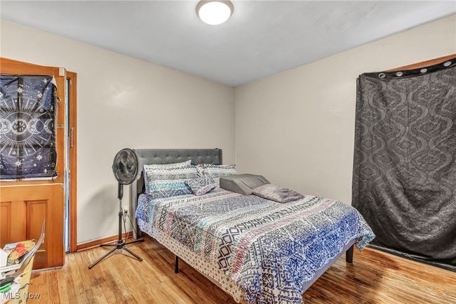 Bedroom with wood-type flooring and baseboards | Image 15
