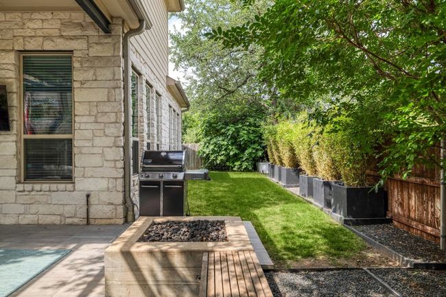 View of yard with a fire pit and a patio | Image 34