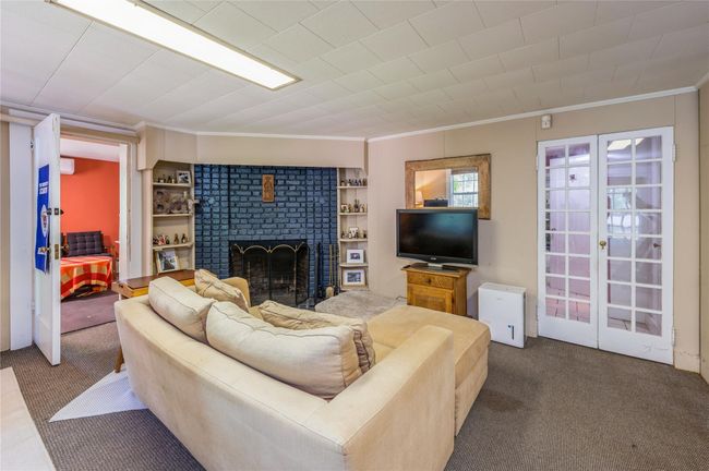 Walk-out lower level family room features cozy fireplace. | Image 26