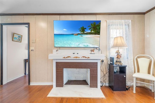 Living area featuring wood finished floors and baseboards | Image 12