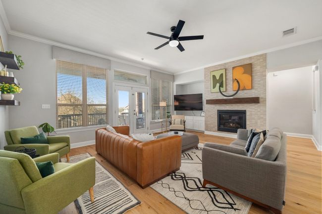 Fabulous tiling on the fireplace and the coziest living room makes for an inviting and peaceful place to be. | Image 11