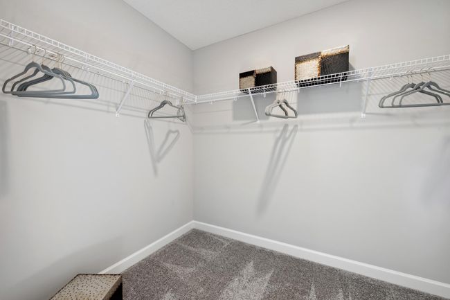 (Photo of decorated model, actual home's finishes will vary) The owner's suite features an incredible walk-in closet. | Image 16