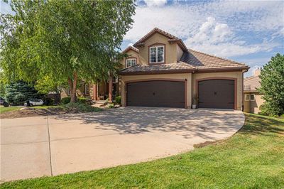 View of front facade with a front lawn and a garage | Image 3