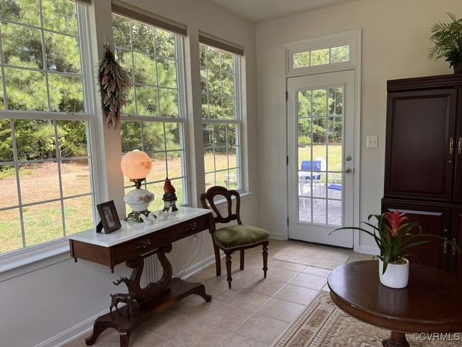 Doorway to outside featuring light tile patterned floors and a healthy amount of sunlight | Image 42