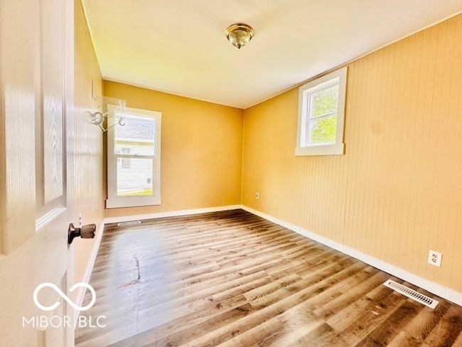 spare room featuring wood finished floors and baseboards | Image 7
