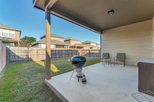 Moving the the back of the home, we notice the fully covered patio perfect for grilling and unwinding at the end of a long week! | Image 25