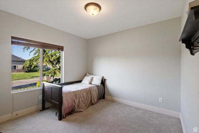 Bedroom featuring light colored carpet and baseboards | Image 12