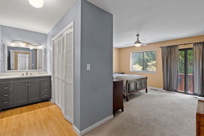 Corridor with baseboards, a sink, and light wood finished floors | Image 5