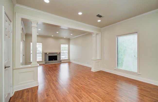 Spacious bedroom with a cozy fireplace and room for a home office. | Image 5
