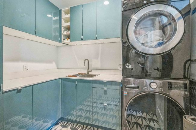 Fully loaded laundry room with sink, located off of the kitchen | Image 10