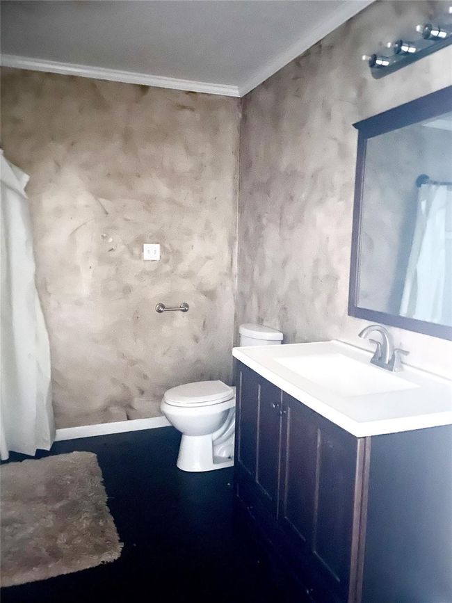 Bathroom featuring vanity and crown molding | Image 7