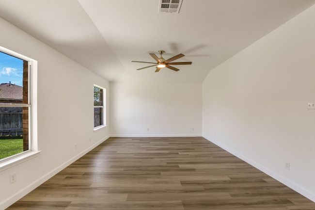 View of the family room. Great natural light with views to the beautiful backyard. All of the baseboards in the home have been replaced as have the ceiling fans. | Image 16