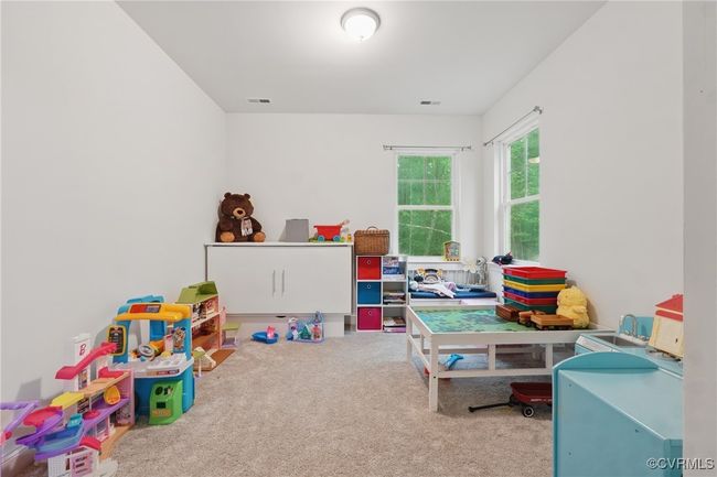 Light-filled bedroom with neutral tones and plush carpeting. | Image 14
