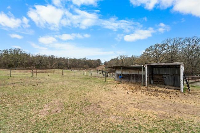 View of yard with a pole building, an outbuilding, an exterior structure, and a rural view | Image 40