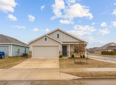 View of front of home featuring a garage and central AC | Image 1