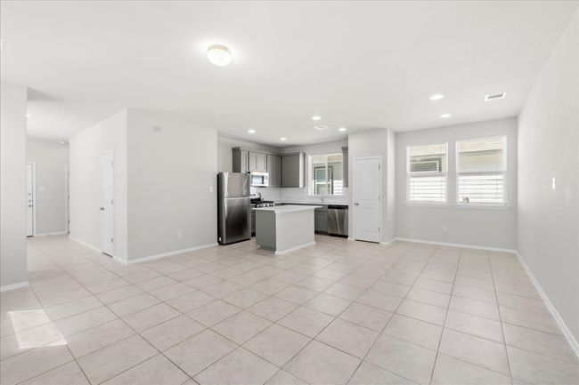 Unfurnished living room with visible vents, recessed lighting, and light tile patterned flooring | Image 8