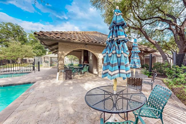 View of patio / terrace featuring outdoor dining area, a community pool, and fence | Image 36